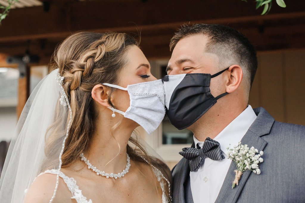 bride and groom in face masks