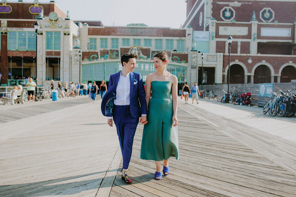 newlyweds walking on boardwalk