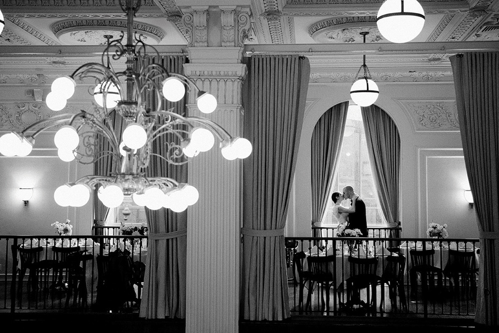 bride and groom kissing in reception room