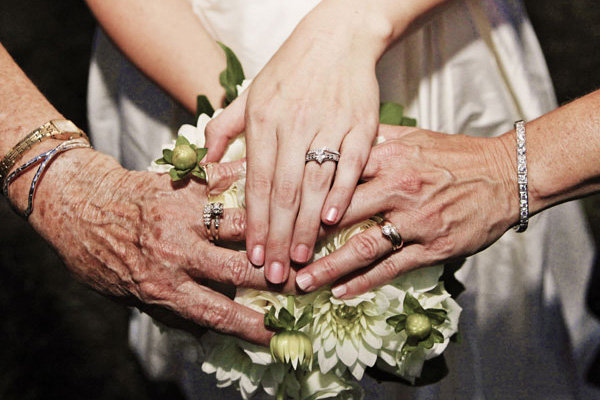 Grandma mom and bride showing off wedding rings