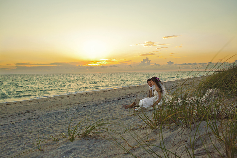 Wedding couple on beach at sunset