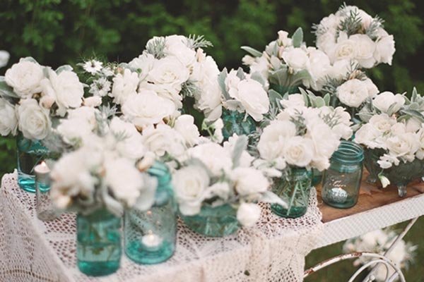 blue mason jars and white flowers