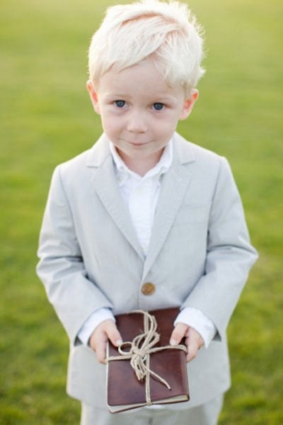 ring bearer holding a vintage novel