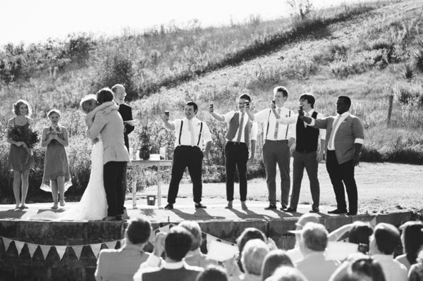 first kiss as husband and wife photographed by the groomsmen on iPhones