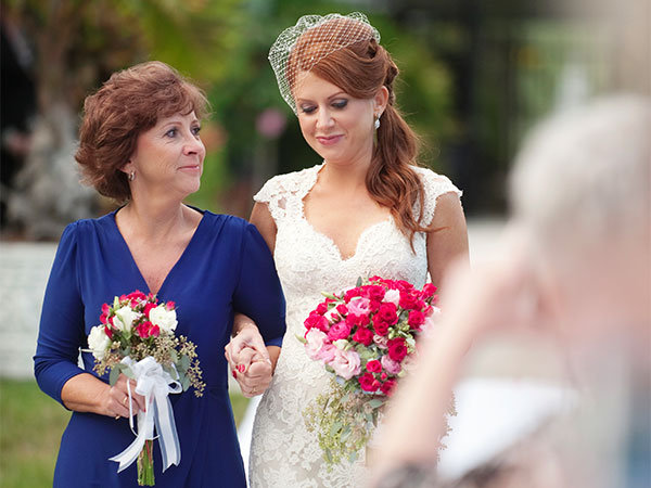 bride walking down the aisle with her mom