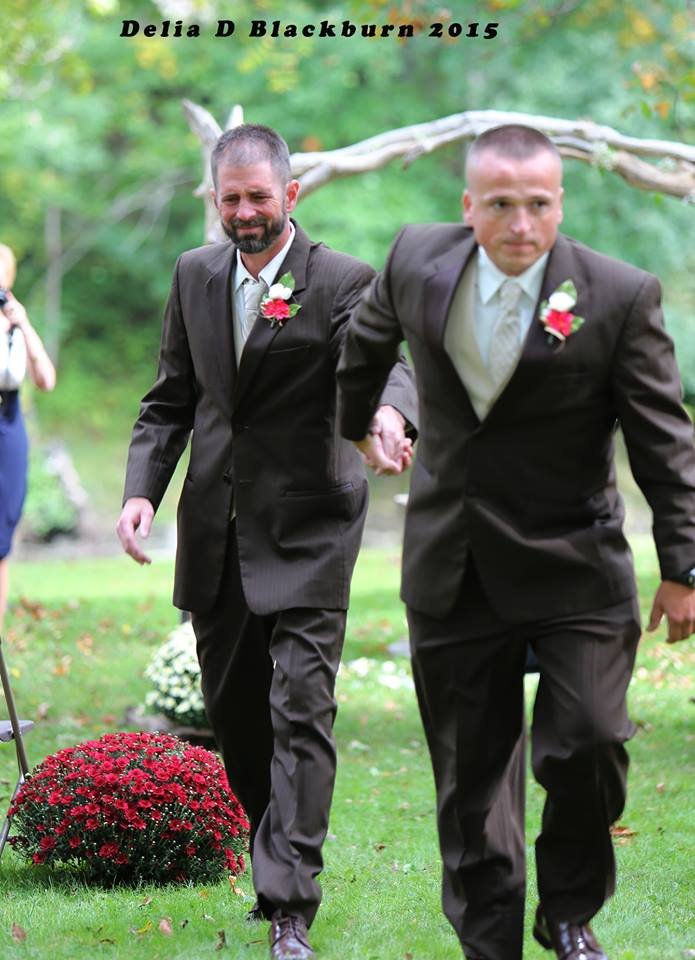 brides father and stepfather walk down the aisle