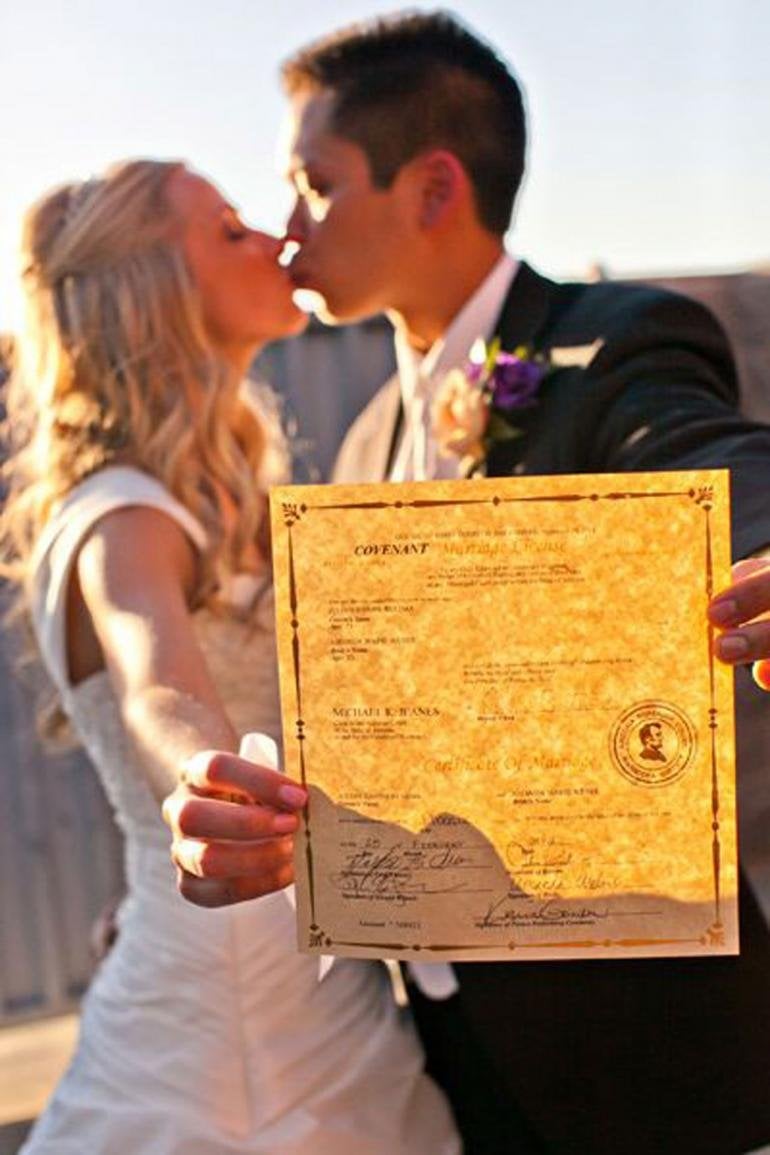 couple holding marriage license