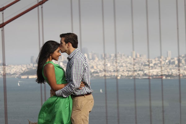 couple standing on bridge