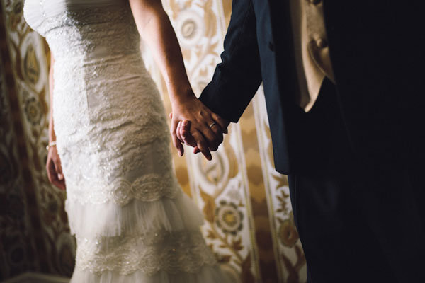 bride and groom holding hands 