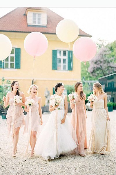 bride and bridesmaids with balloons