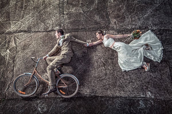 Groom and groomsman making funny poses for wedding pictures | ClipStock