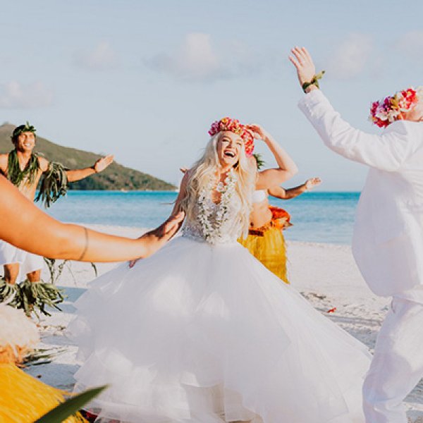 Bride and groom dancing on the beach