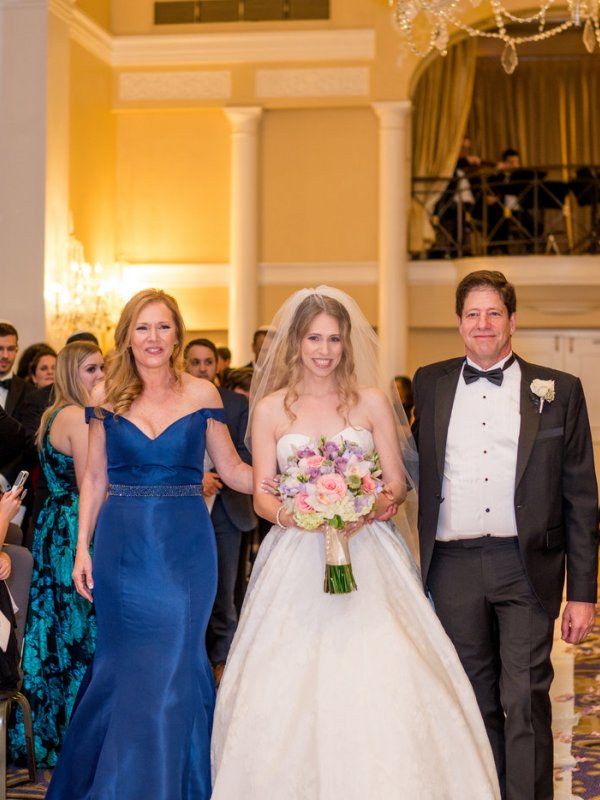 Bride walking down the aisle with parents Bride walking down the aisle with parents