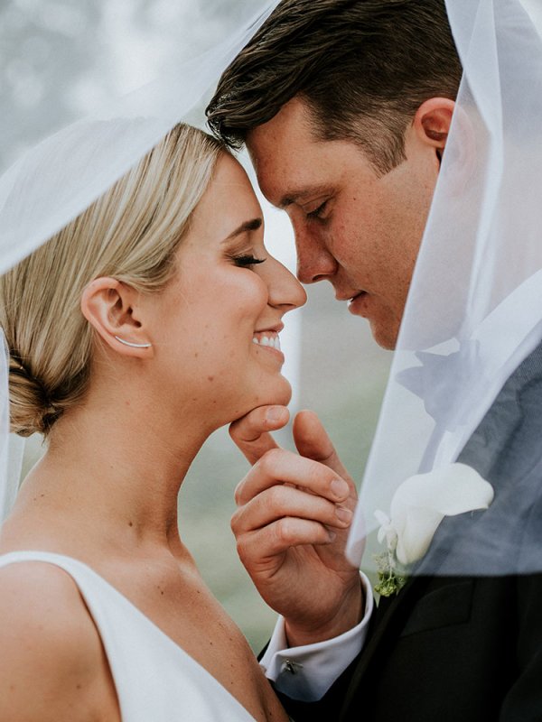 Bride and Groom Kissing Under Veil Bride and Groom Kissing Under Veil