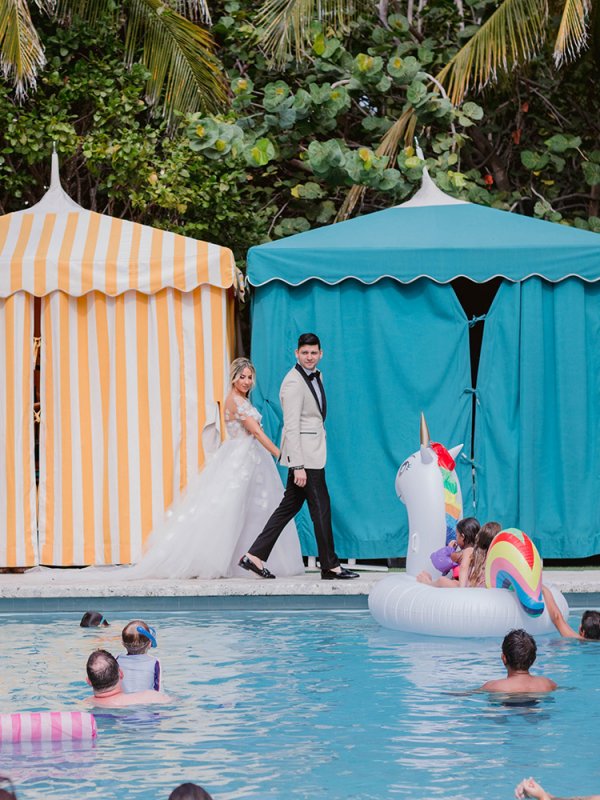 Bride and groom walking around a pool Bride and groom walking around a pool