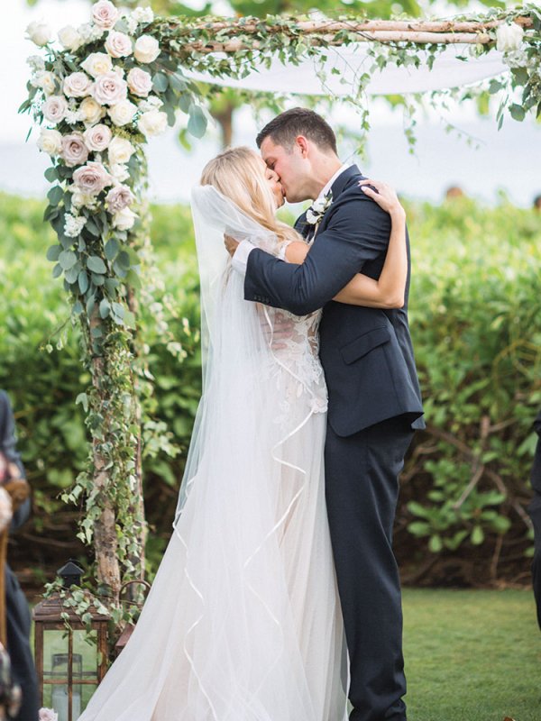 Bride and groom kissing at wedding ceremony Bride and groom kissing at wedding ceremony