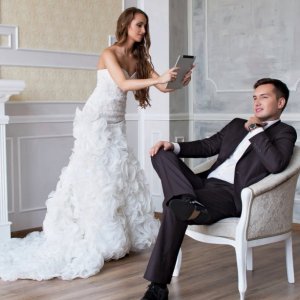 bride taking picture of groom